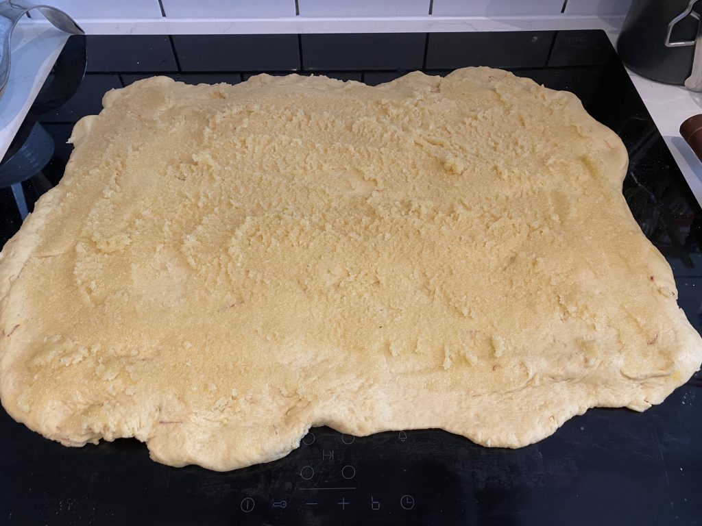 Dough for Saffransbullar topped with almond paste