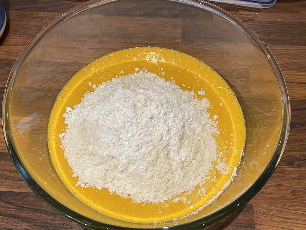 Adding flour to the blended carrot mixture