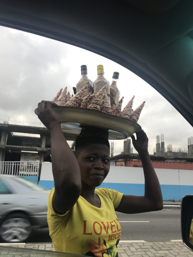 Lady selling roasted peanuts in Lagos, Nigeria