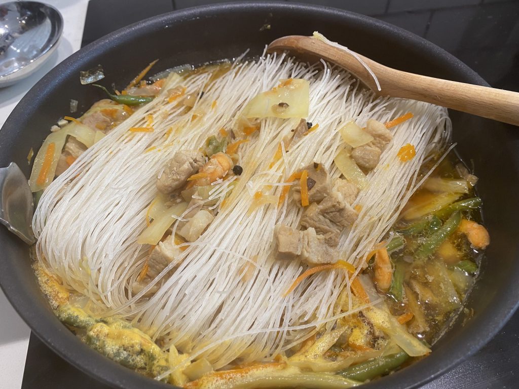 Final step, adding the rice noodles to the pancit