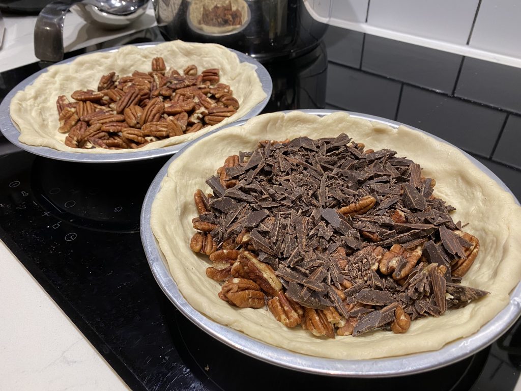 Adding pecans and chocolate to the crusts