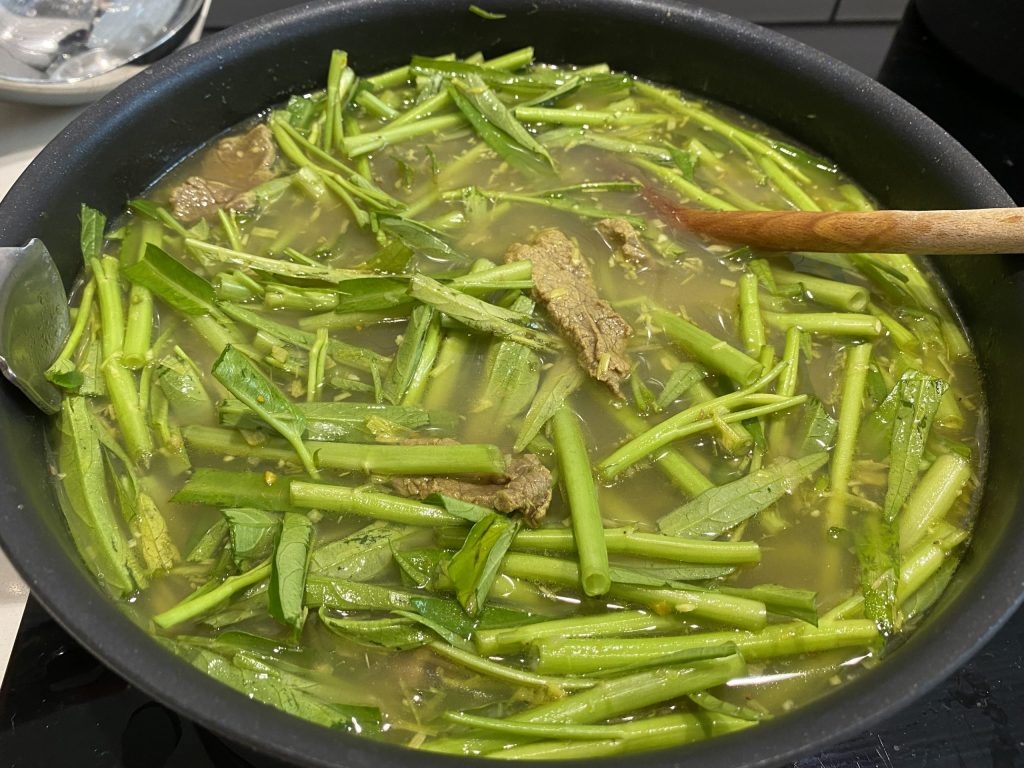 Adding the water spinach to the beef