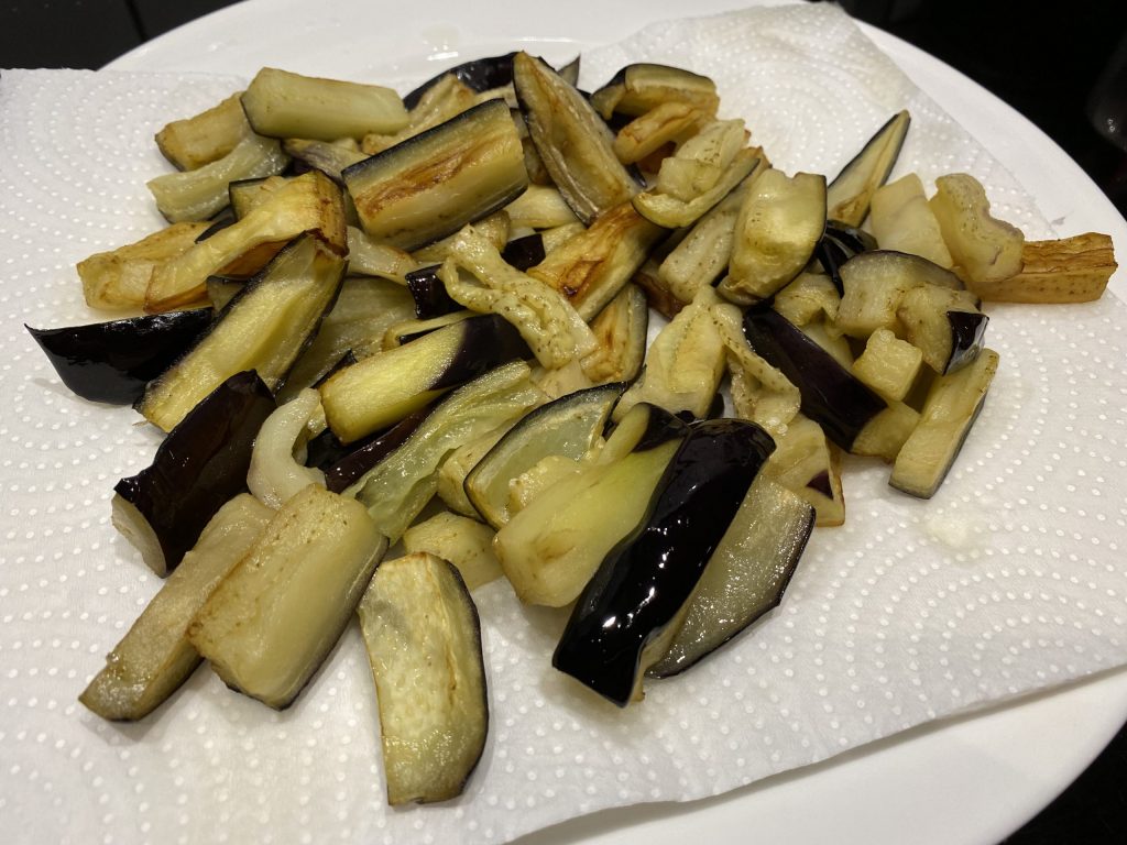 Draining the fried aubergines