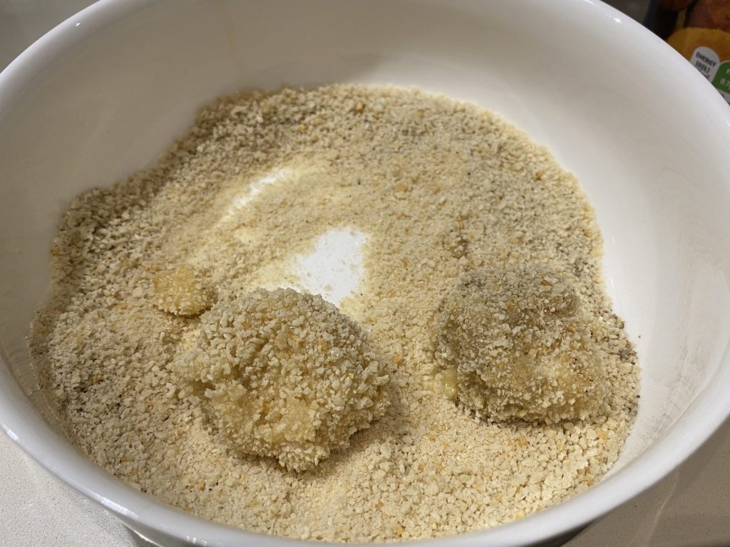 Double-coating the tofu with egg and breadcrumbs