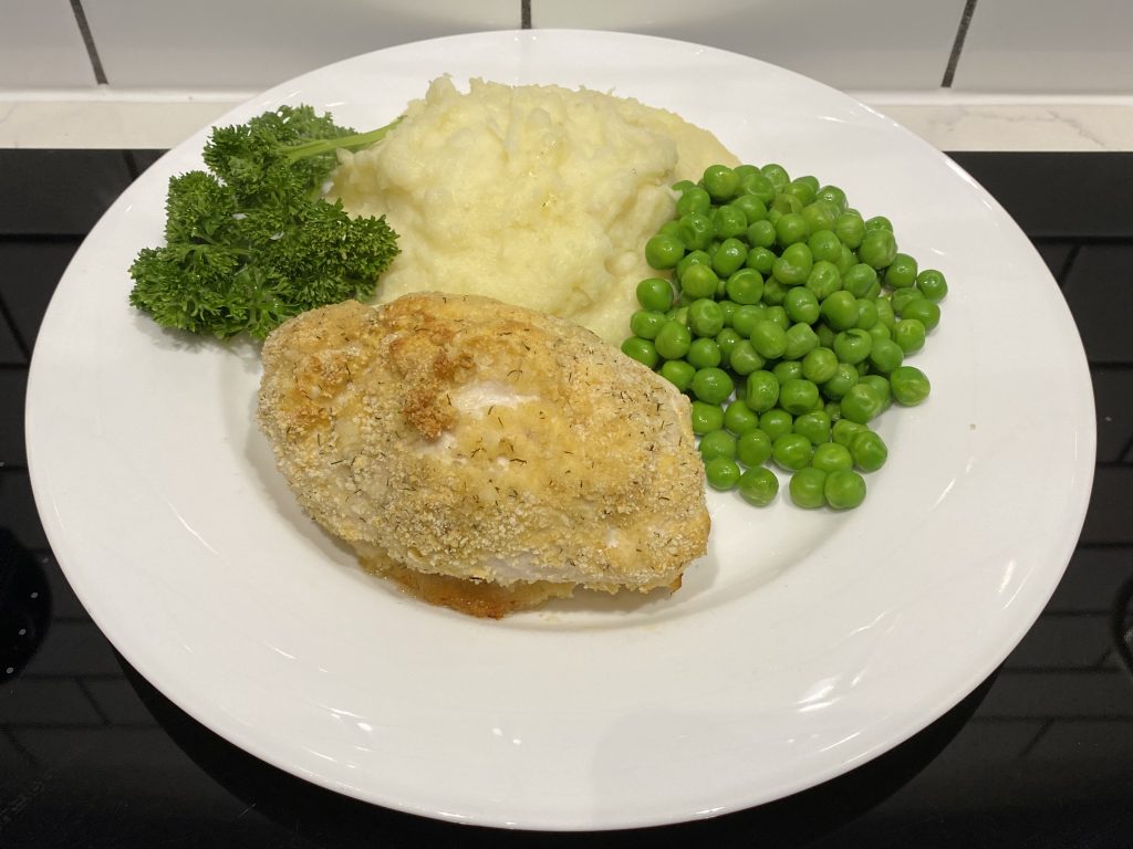 Chicken Kyiv with mashed potato and peas