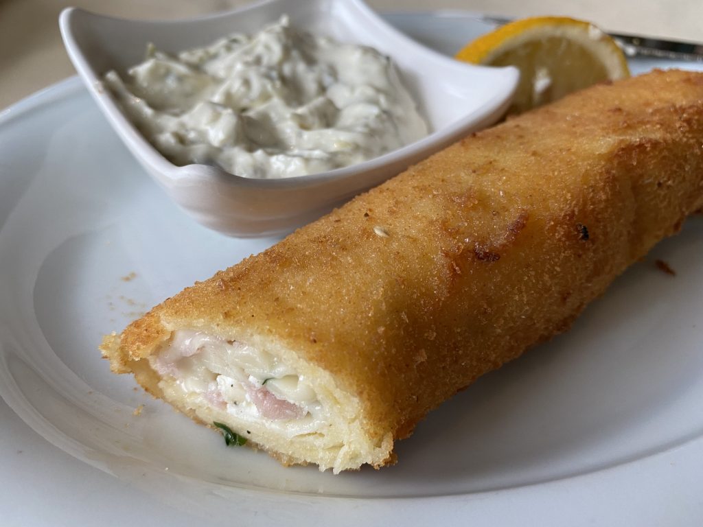Dukat piroshka -long, fried, breaded roll filled with cheese and ham and served with pickle mayonnaise