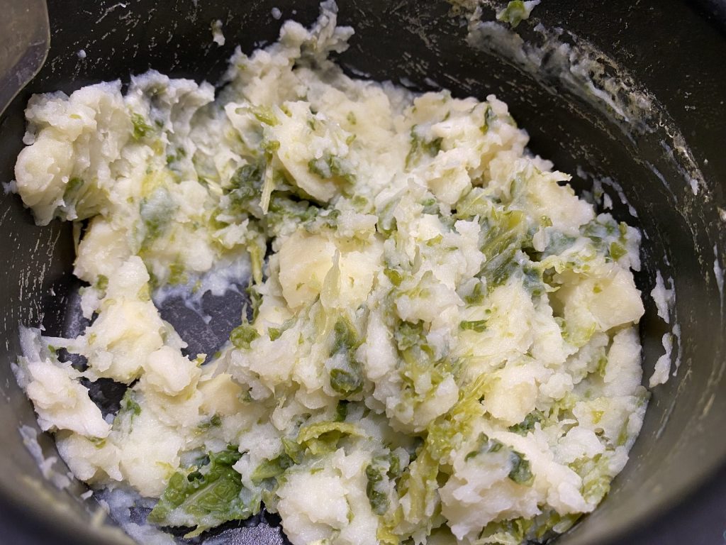 Mashing the potato and cabbage