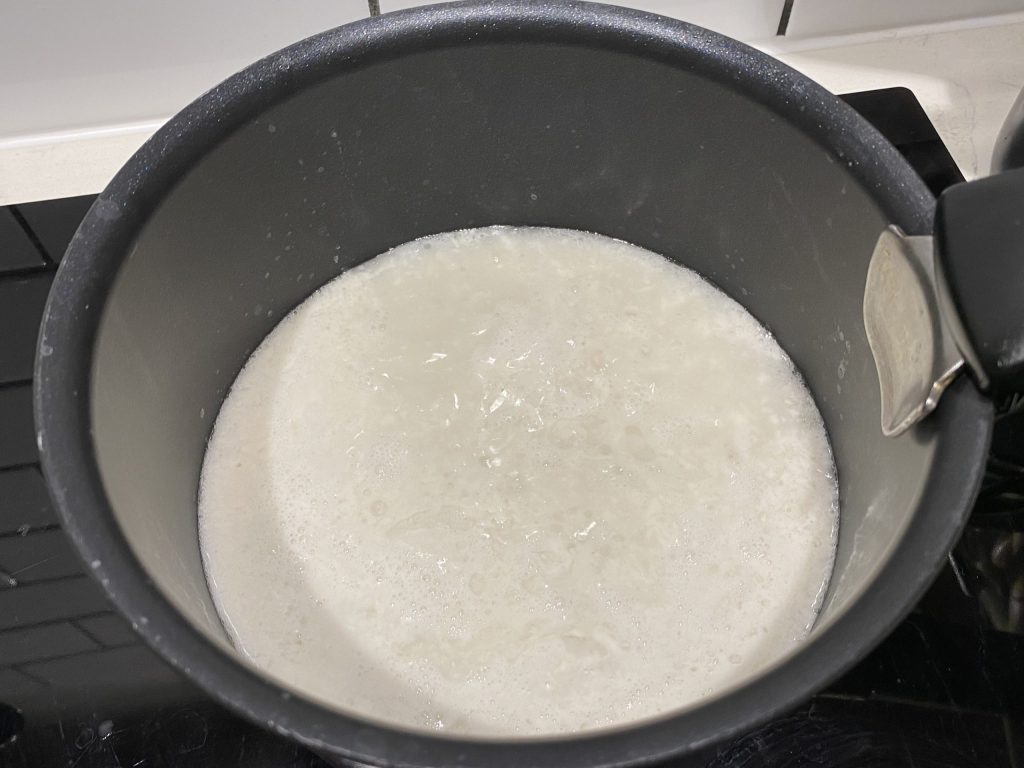 Heating the coconut milk to boiling