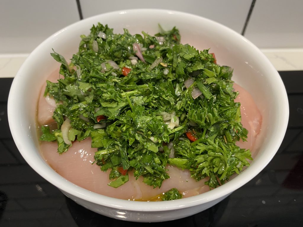 Marinating the chicken in the chimichurri