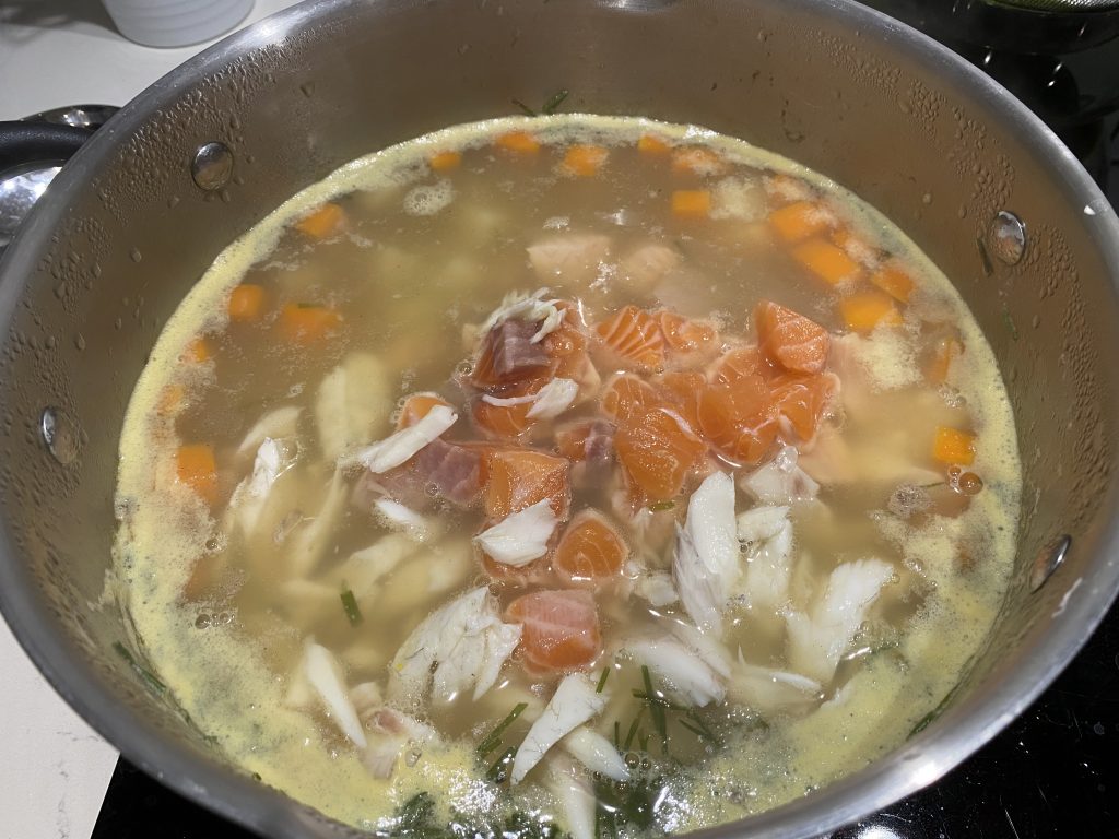 Adding the fish to the soup