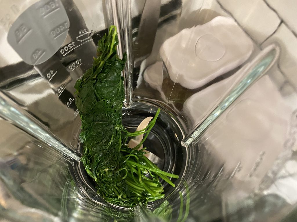 Add the herbs and olive oil to a blender