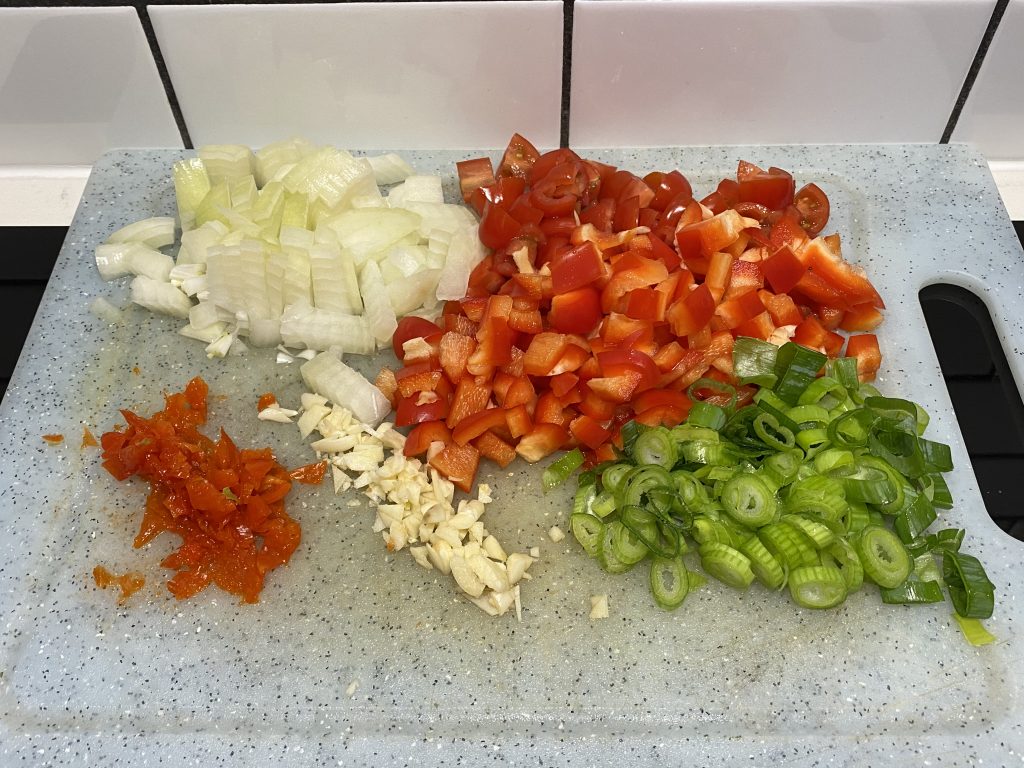 Spring onion, red pepper, onion, Scotch bonnet pepper, garlic, and tomatoes for Callaloo