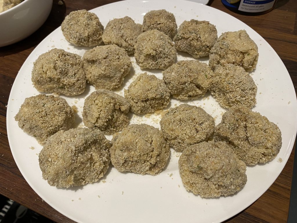 Rolling the meatballs in flour, egg and breadcrumbs