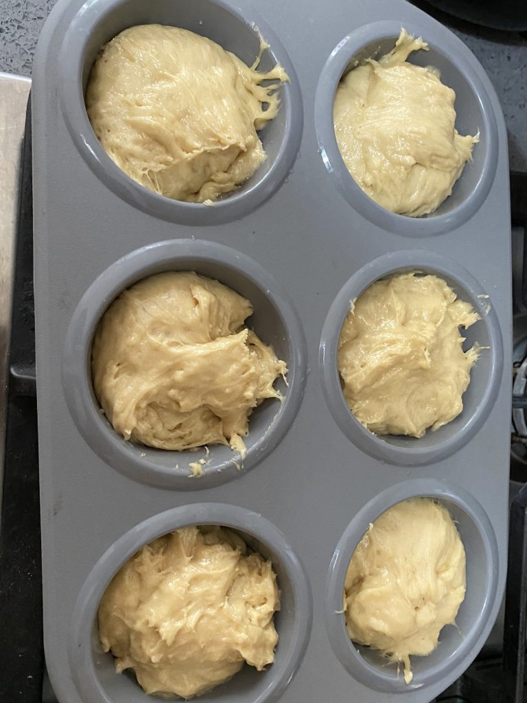 Baba dough in the muffin cups before rising