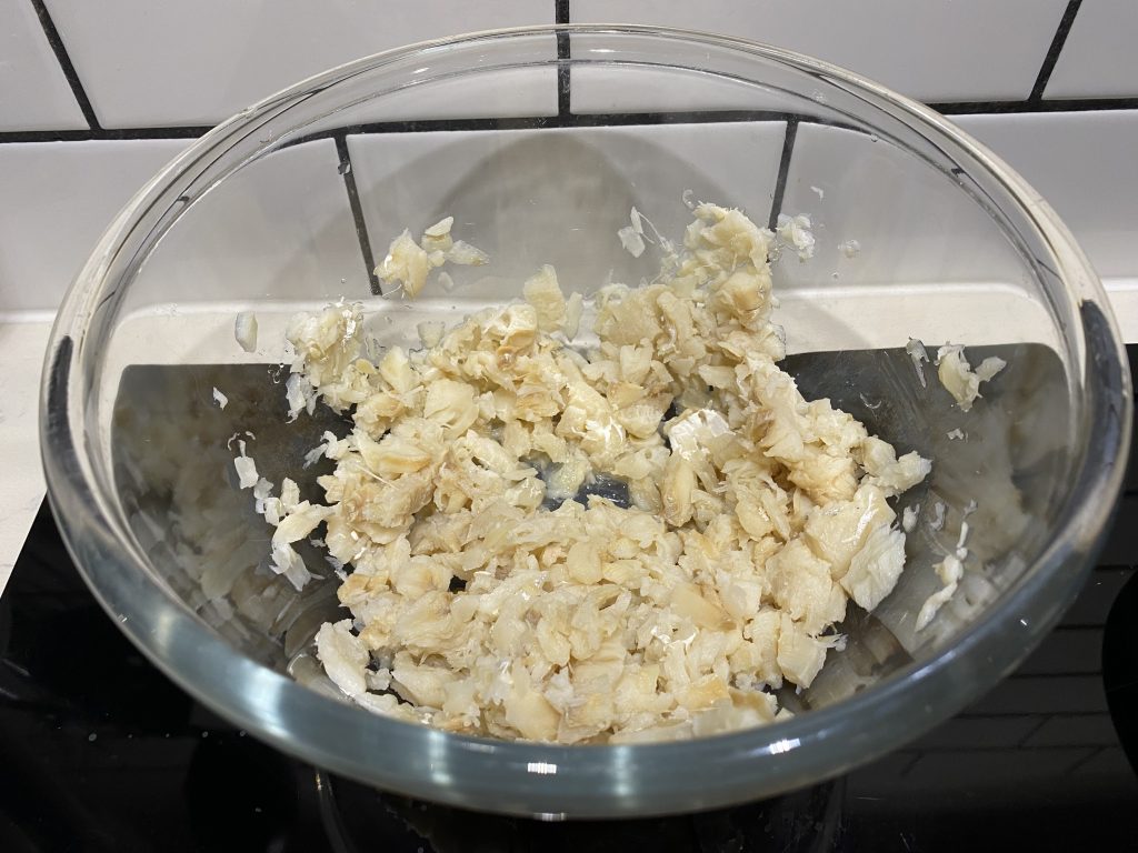 Breaking up the bacalhau into pieces