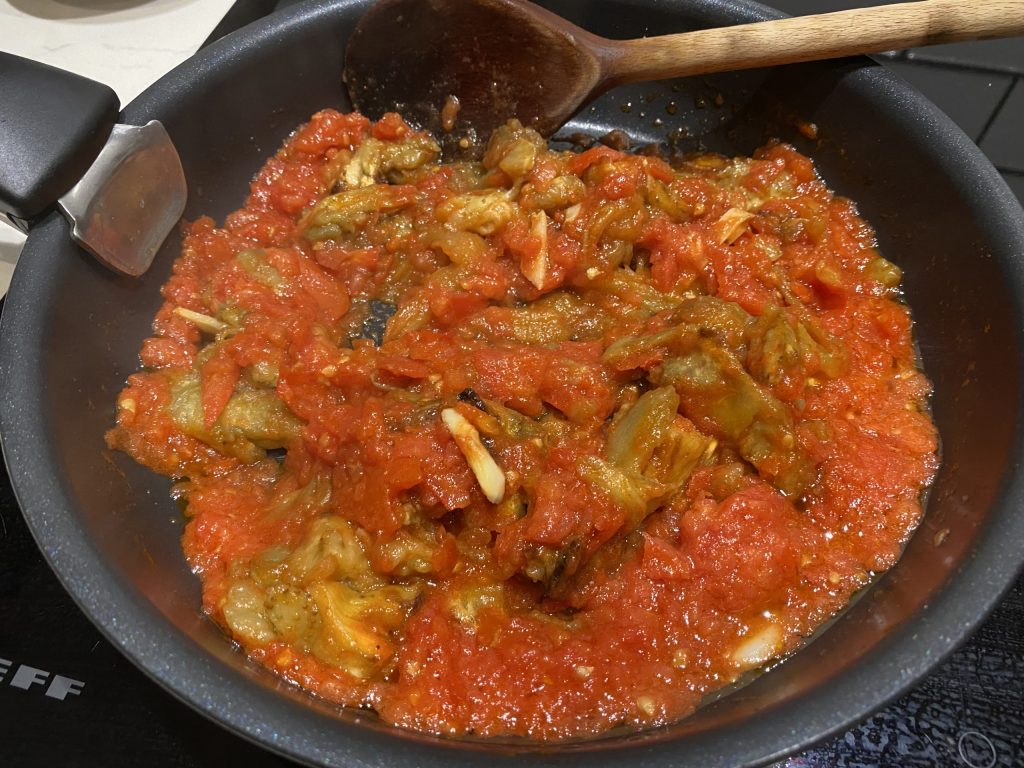 Add aubergine to the tomato mixture
