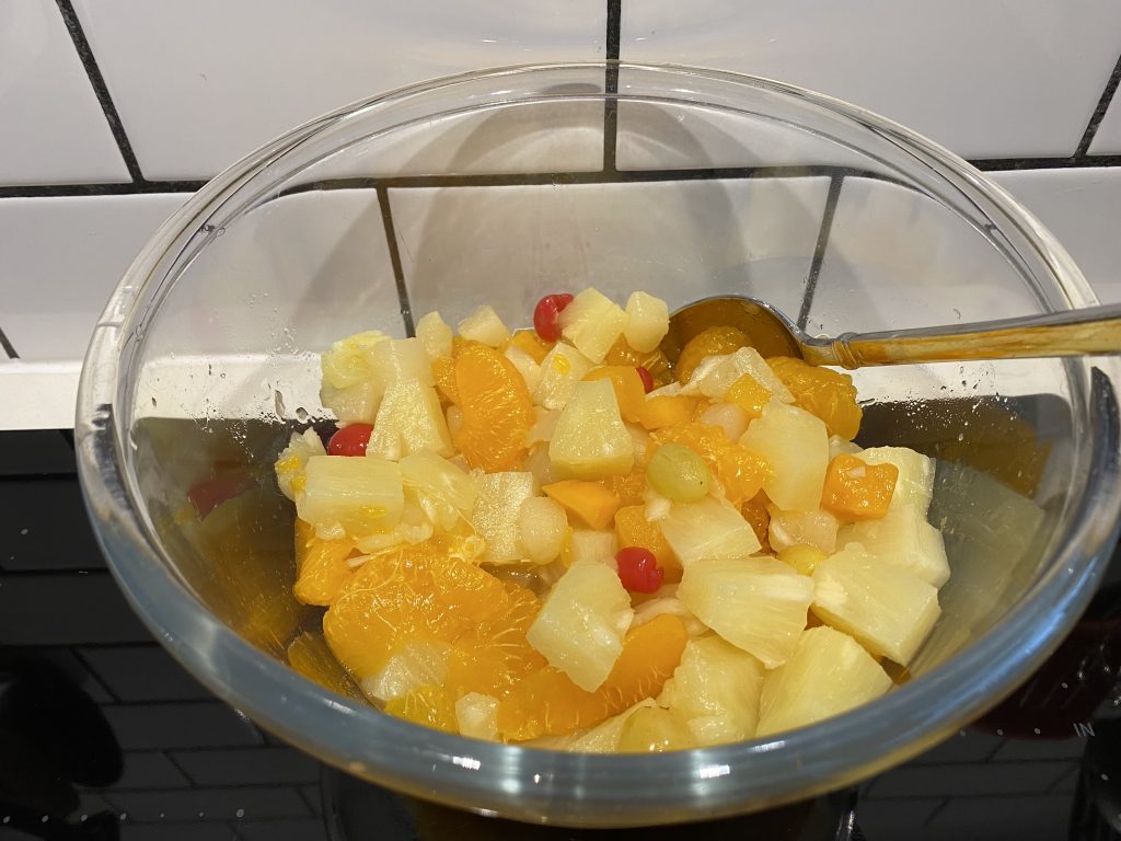 Empty all of the tinned fruit into a bowl