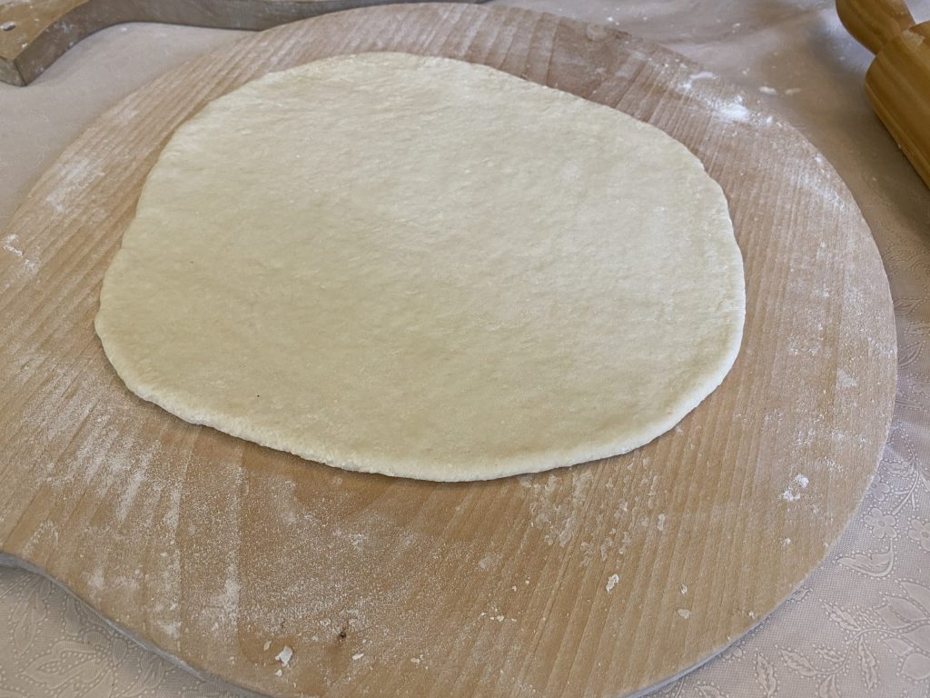 Rolling out the khinkali dough