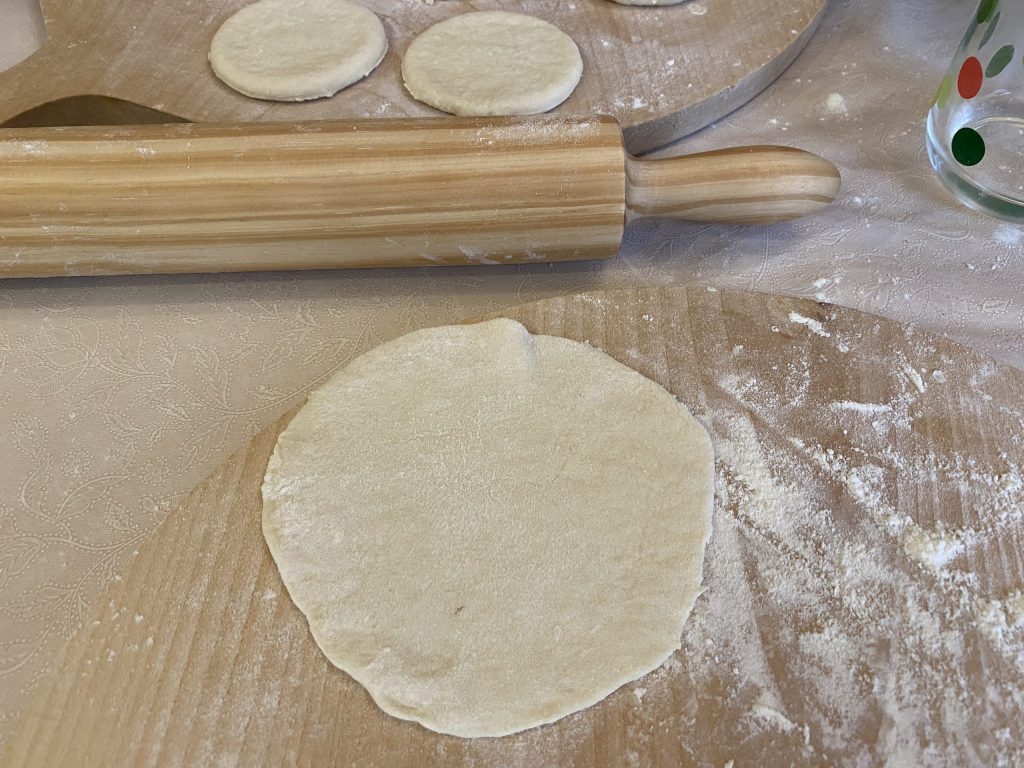 Rolling out the khinkali dough into circles