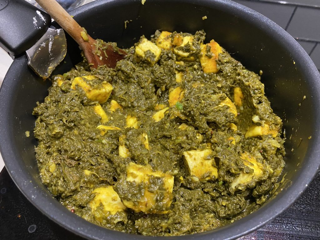 Adding the spinach (saag)