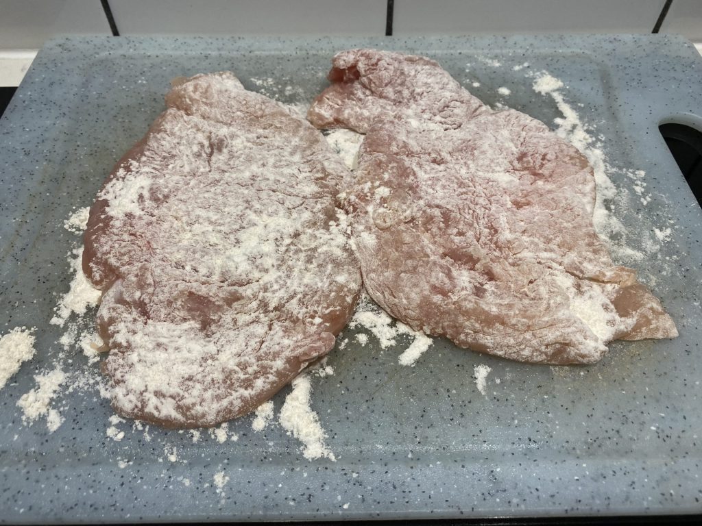Coat pounded meat with flour